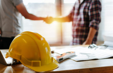 yellow safety helmet on workplace desk at construction site